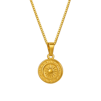 Gold necklace with a round pendant on a white background