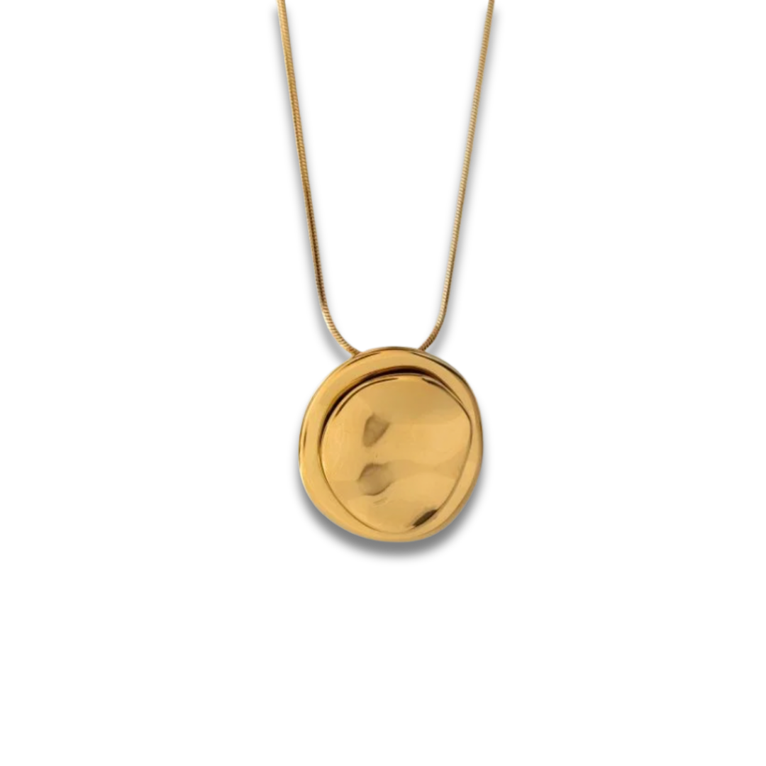 Gold necklace with a round pendant on a white background