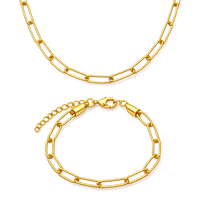 Gold chain necklace and bracelet on a white background
