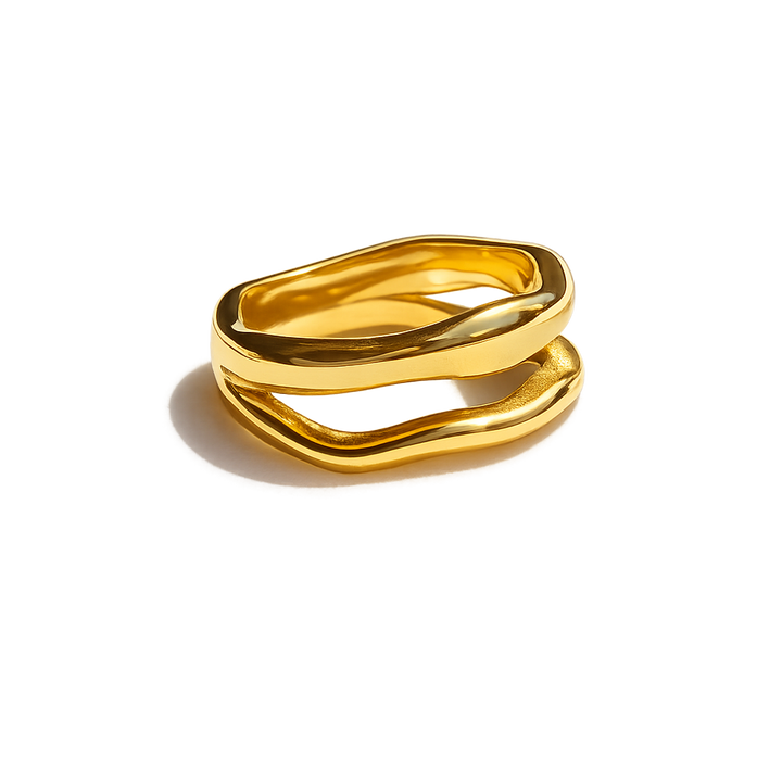Gold ring with a wavy design on a white background
