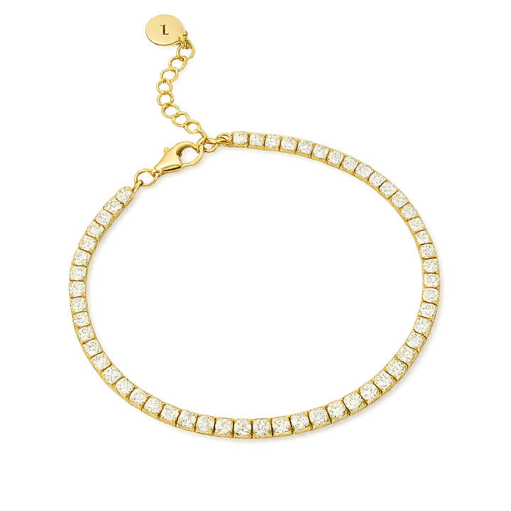 Gold tennis bracelet with clear stones on a white background