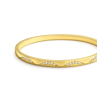 Gold bracelet with small diamonds on a white background