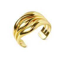 Gold bracelet with wavy design on a white background