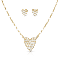 Gold heart-shaped necklace and earrings on a white background