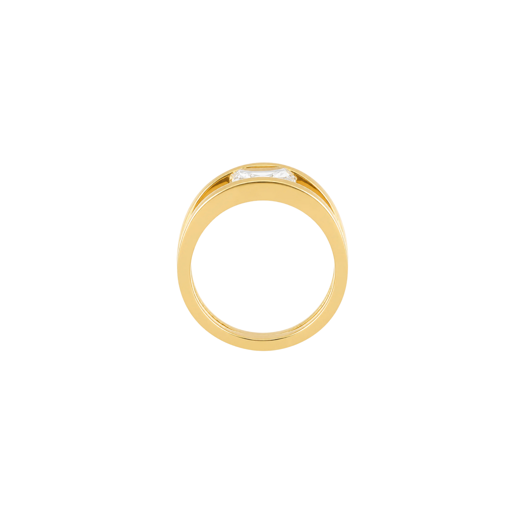 A gold ring with a small rectangular clear gemstone, shown from a top-down view on a plain white background.