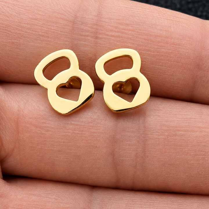 Gold earrings shaped like the number '8' on a person's hand.