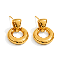 A pair of polished gold-toned hoop earrings with a thick, rounded circular design and post backings, shown on a clean white background.