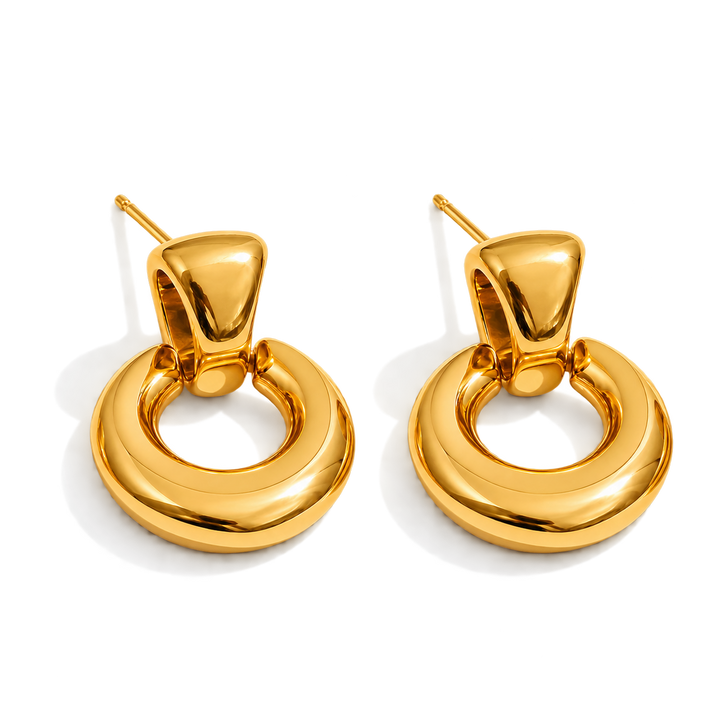 A pair of polished gold-toned hoop earrings with a thick, rounded circular design and post backings, shown on a clean white background.