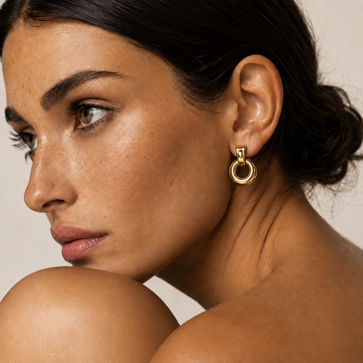 gold knocker hoop earrings on model