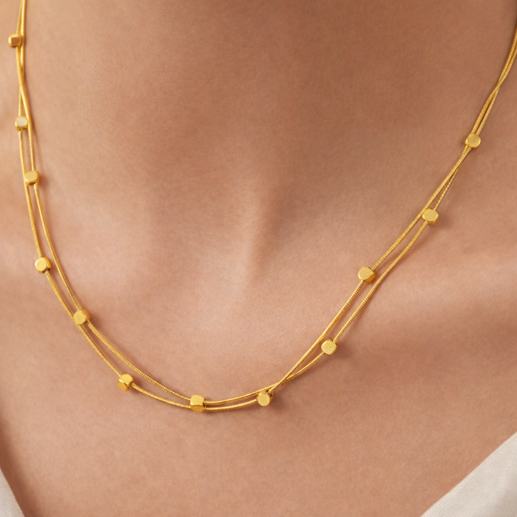 layered gold necklace with square details