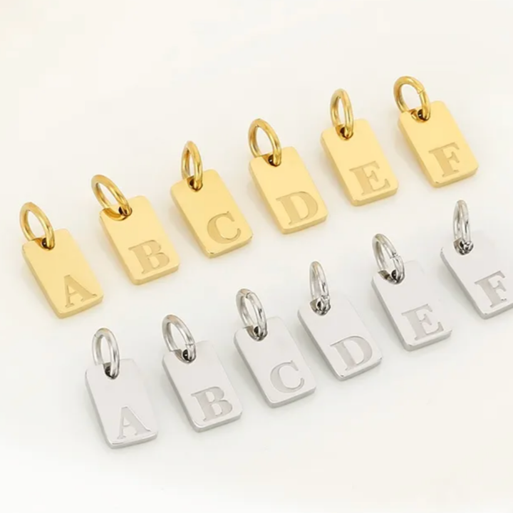 Gold and silver letter tags from A to F on a white background