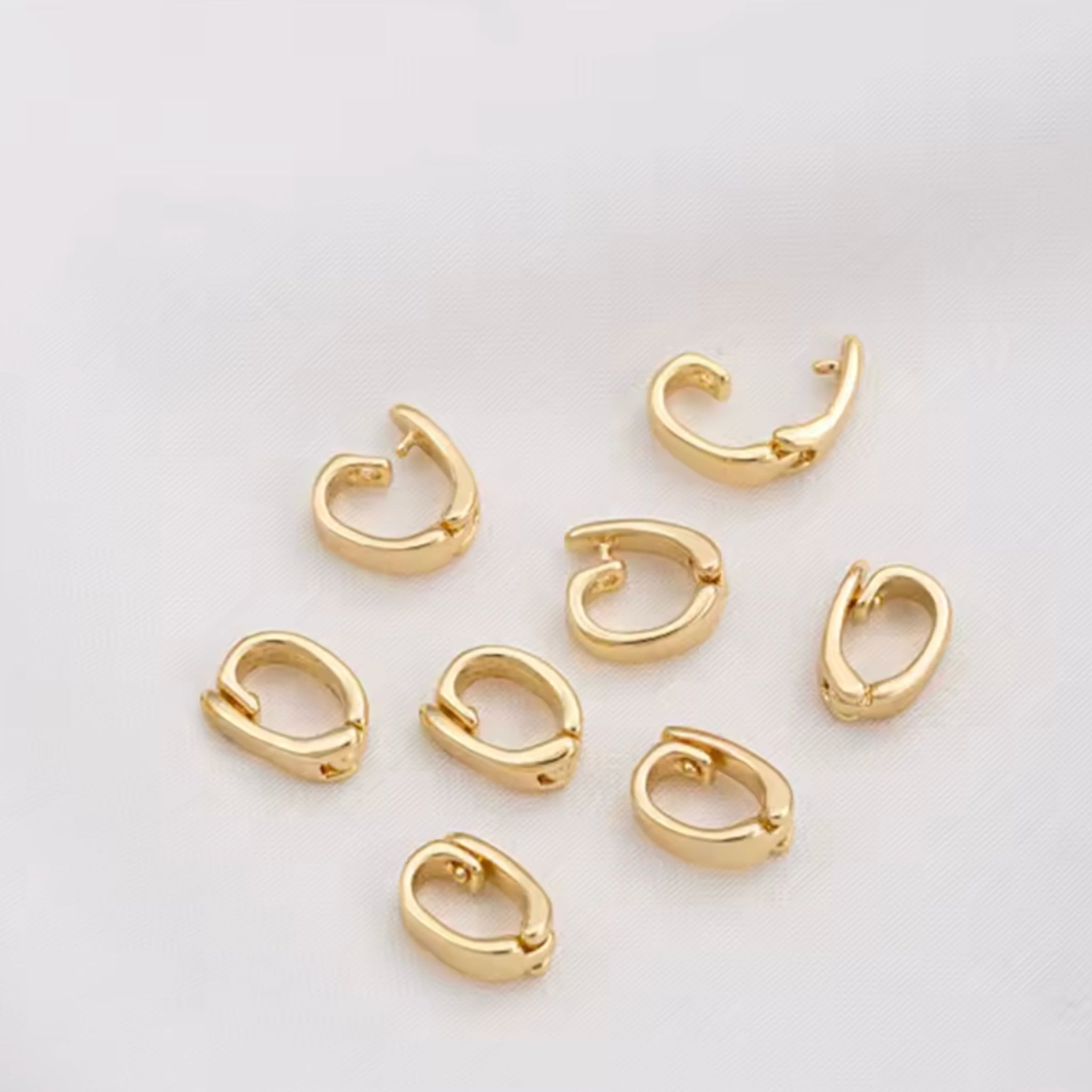 Gold hoop earrings on a light gray background