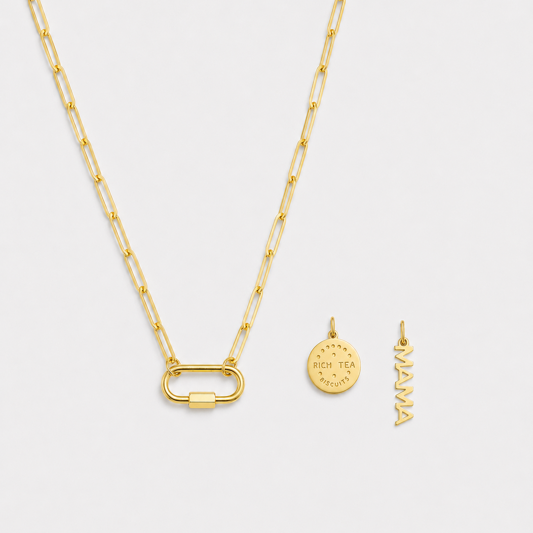 Gold necklace with two pendants on a light gray background