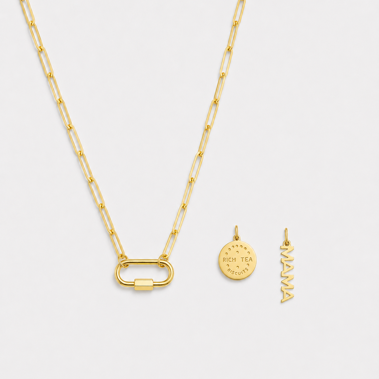 Gold necklace with two pendants on a light gray background