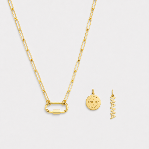 Gold necklace with two pendants on a light gray background