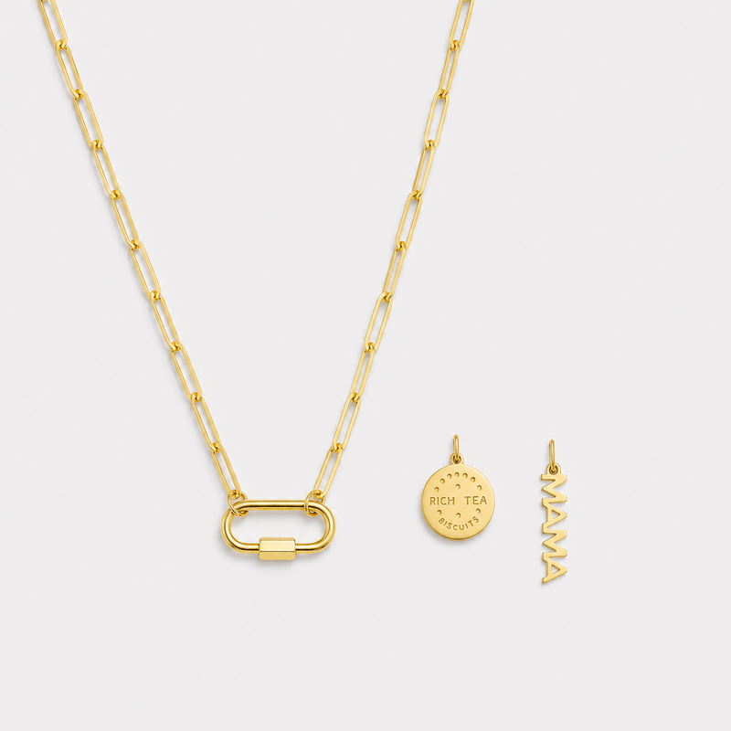 Gold necklace with two pendants on a light gray background