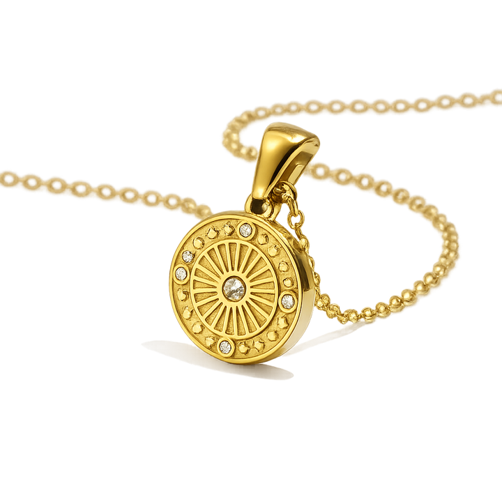 Gold necklace with a round pendant on a white background