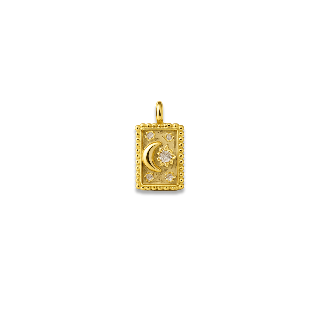 Gold pendant with moon and star design on a white background