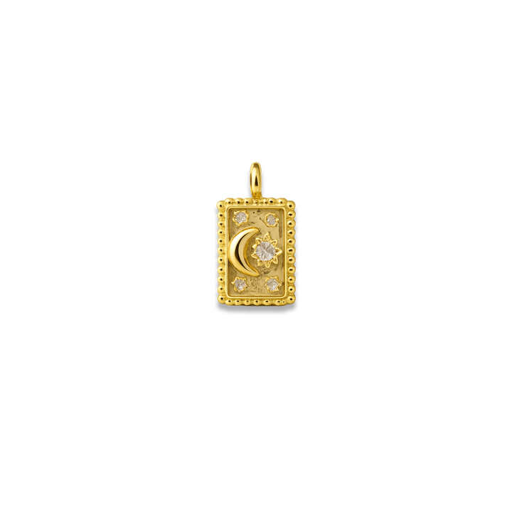Gold pendant with moon and star design on a white background