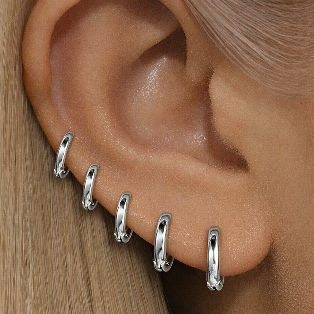 stacked silver hoops in ear