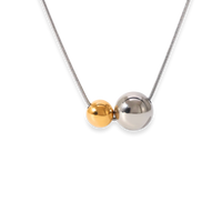Necklace with two spherical beads, one gold and one silver, on a white background