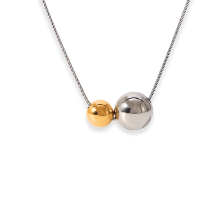 Necklace with two spherical beads, one gold and one silver, on a white background