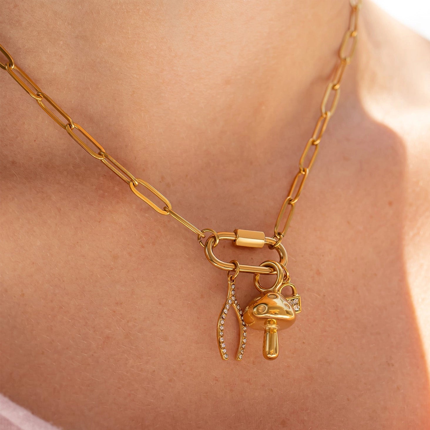 Gold necklace with charms on a person's neck