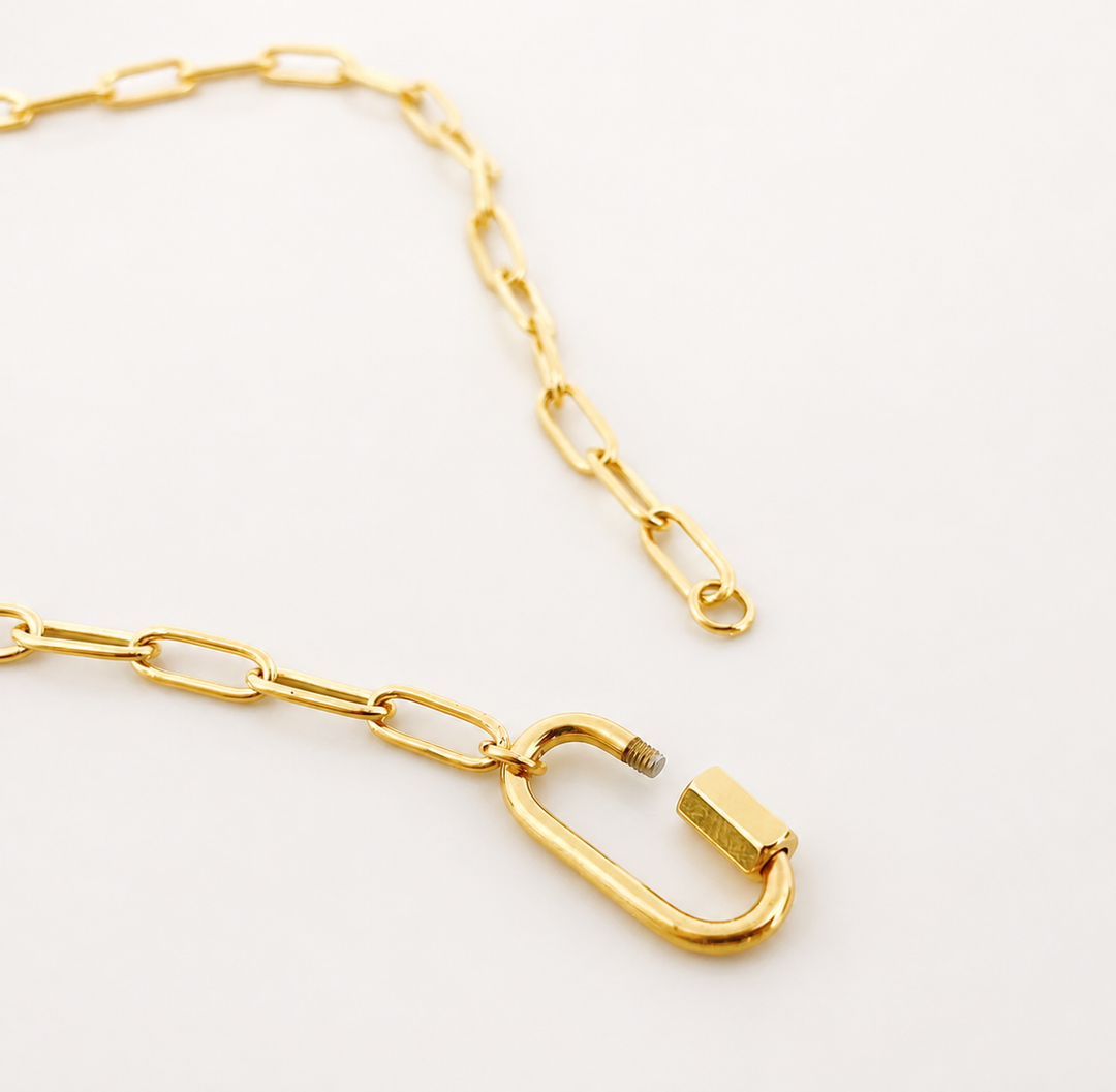 Gold chain necklace with a unique clasp on a white background