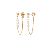 A pair of gold hoop earrings with a dangling chain and three white freshwater pearls on each earring, shown against a plain white background.