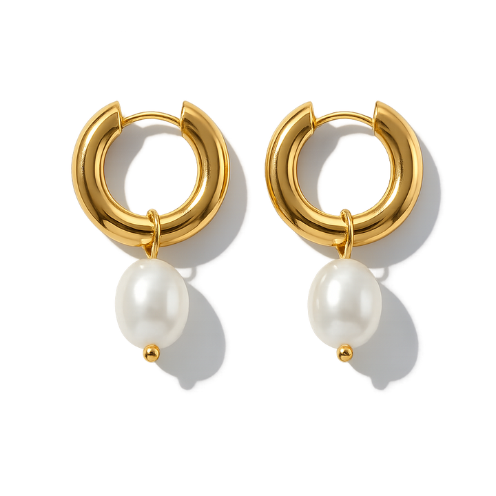 Gold hoop earrings with pearl drops on a white background
