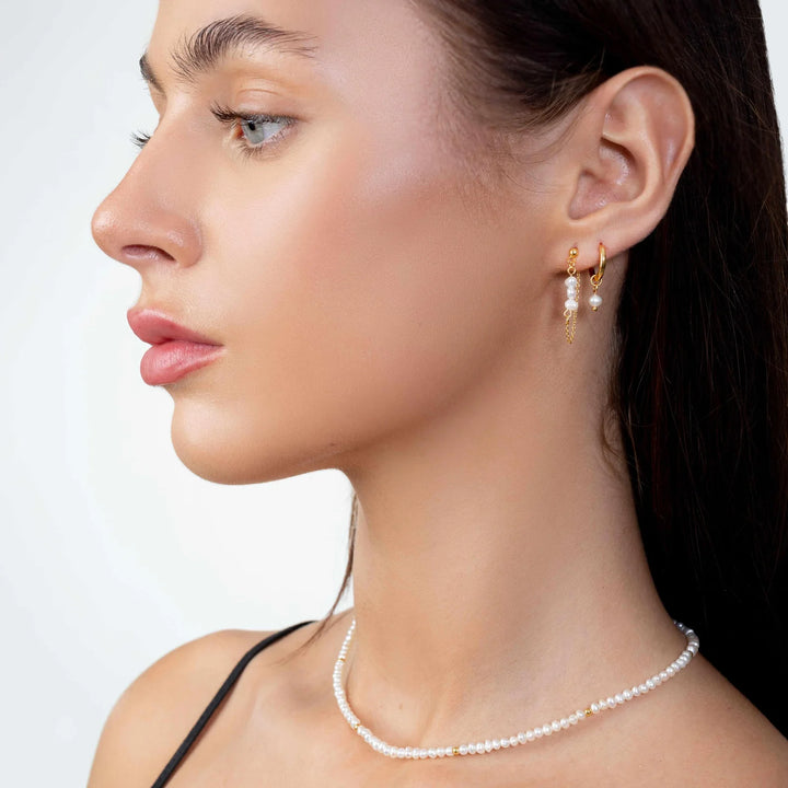 pearl earrings drop in gold on model