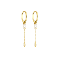 Gold hoop earrings with clear gemstones on a white background