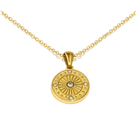 Gold necklace with a round pendant on a white background