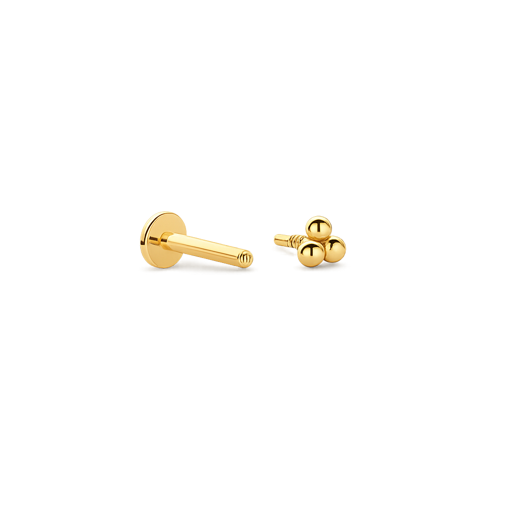 Gold piercing earring on a white background