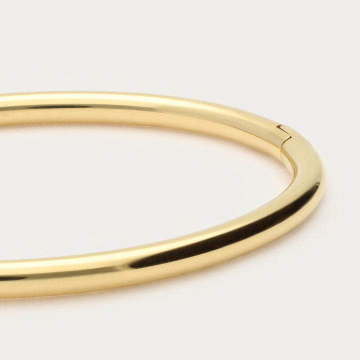 Gold bangle on a white background