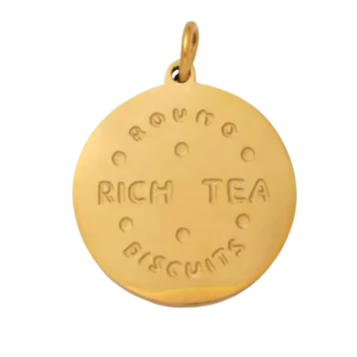 Gold pendant with engraved text on a white background