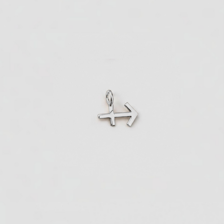 Silver arrow-shaped pendant on a light gray background
