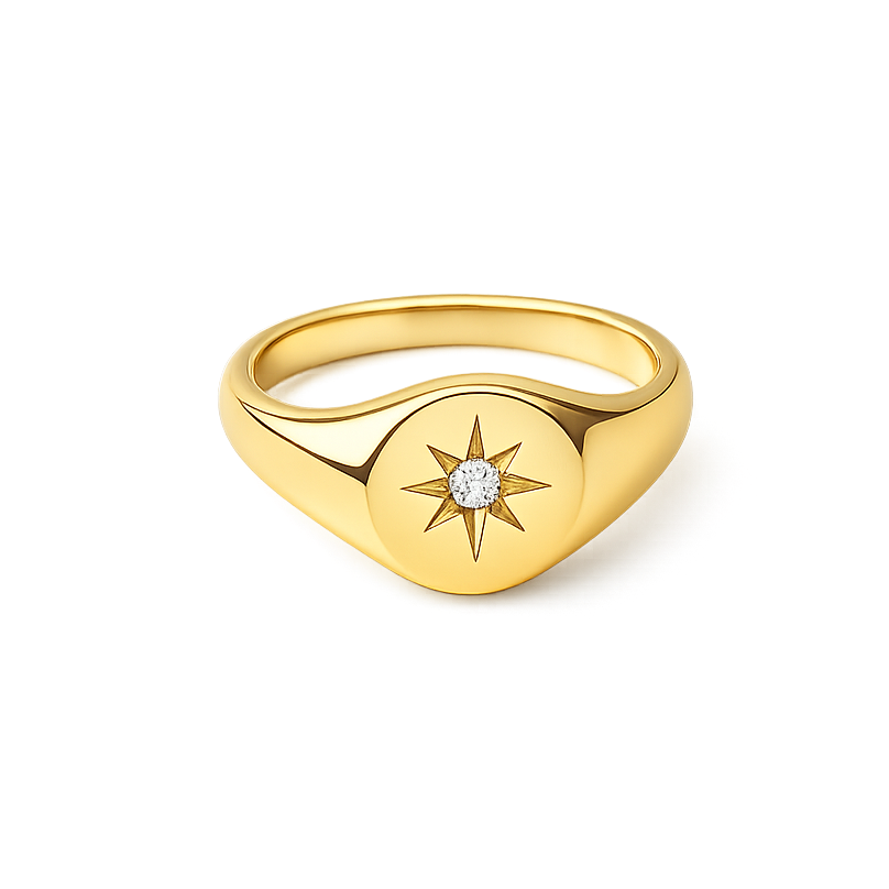 Gold ring with star design and diamond on a white background