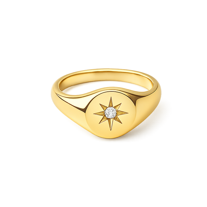 Gold ring with star design and diamond on a white background