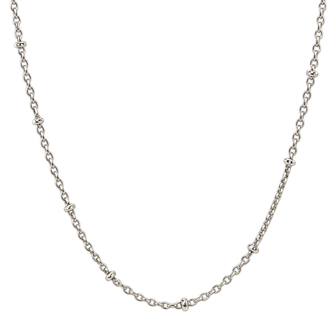 A silver-toned chain necklace with small, repeating decorative links spaced evenly along the curve, displayed against a solid white background.