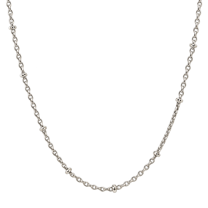 A silver-toned chain necklace with small, repeating decorative links spaced evenly along the curve, displayed against a solid white background.
