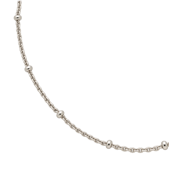 A gold chain necklace featuring evenly spaced, polished round bead links, shown against a solid white background.