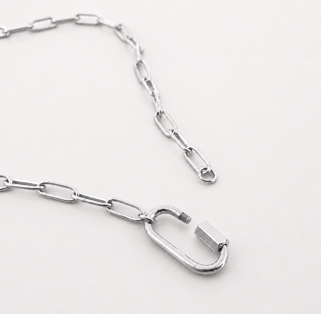 Silver chain with a carabiner on a white background