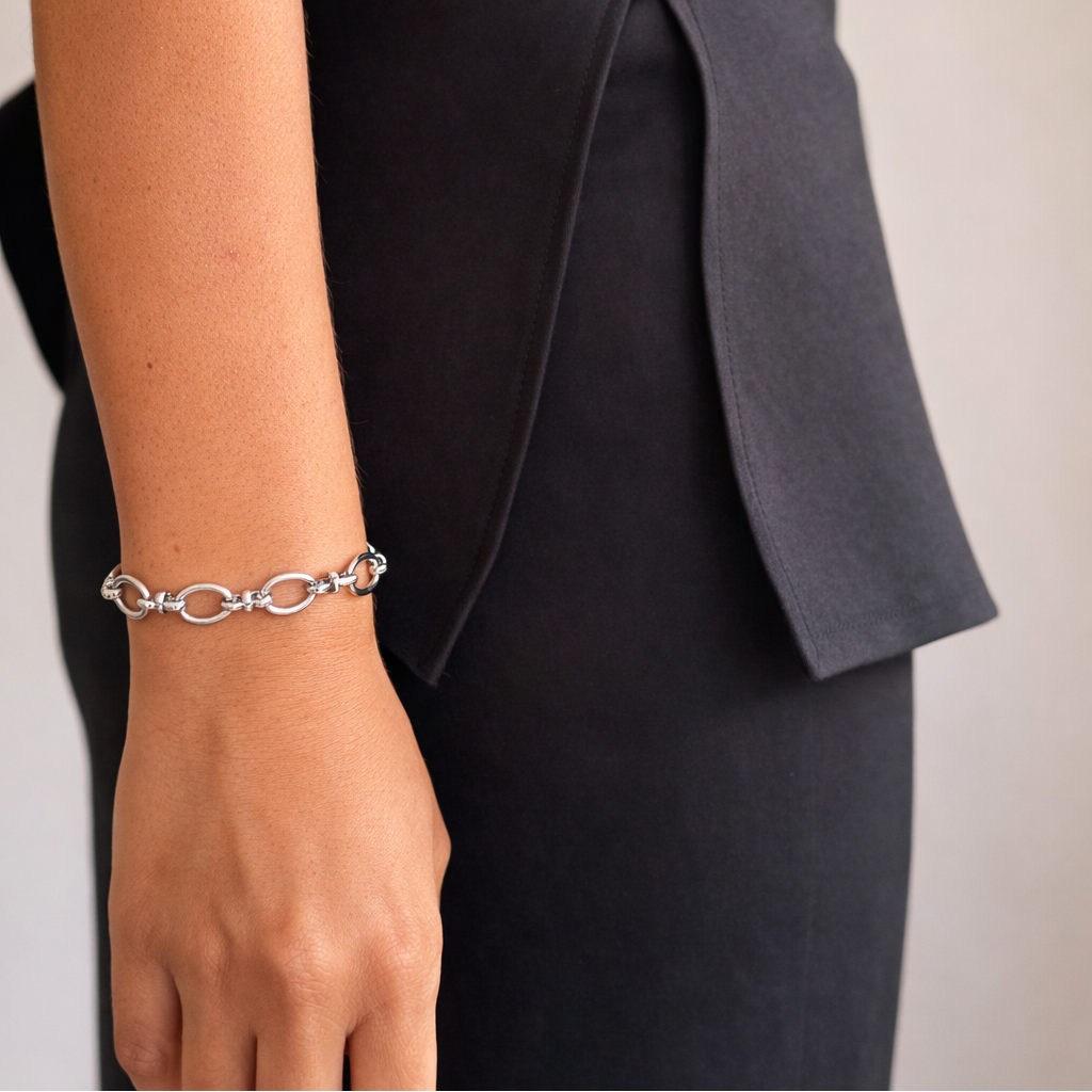 Silver bracelet on a person's wrist with a blurred background