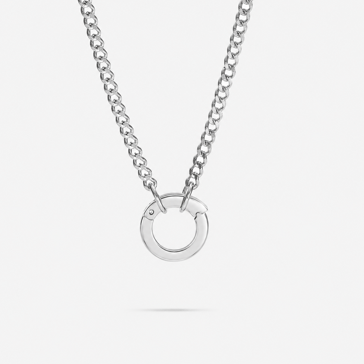 Silver necklace with a circular pendant on a white background