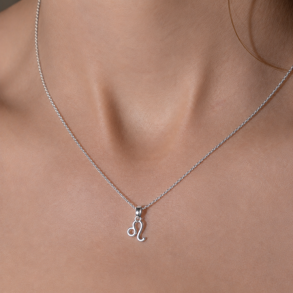 Silver necklace with a pendant on a person's neck