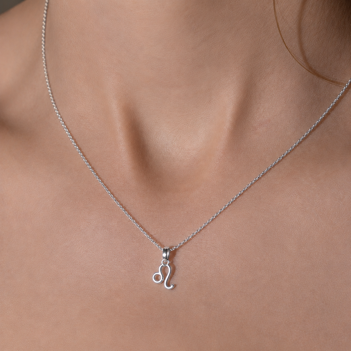 Silver necklace with a pendant on a person's neck