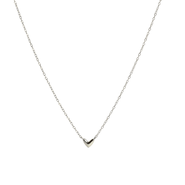 A delicate silver chain necklace with a small, polished silver heart pendant, displayed against a solid white background.
