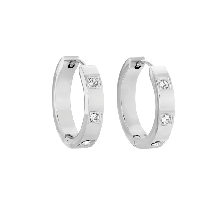 Pair of silver hoop earrings with embedded crystals on a white background