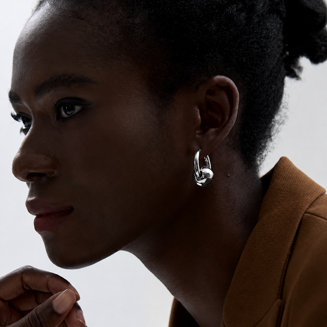 Woman wearing a silver earring with a blurred background